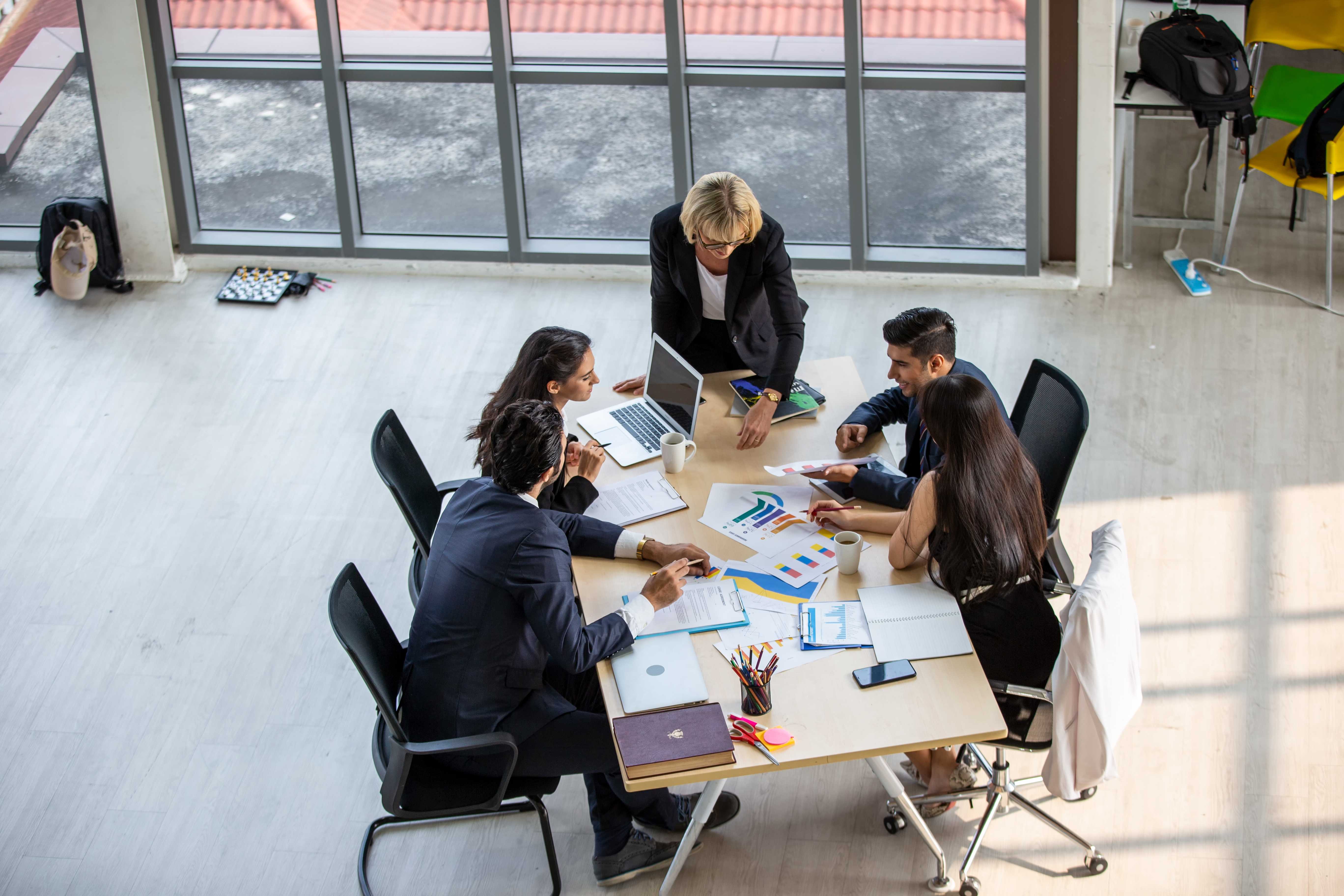 Coworkers around a board room table